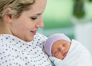 Mother holding her newborn baby after having given birth