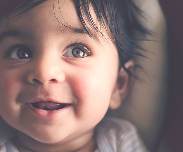 Close up of baby smiling and looking up