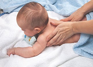 mother giving a baby massage