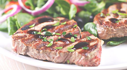 cooked lean red meat and salad