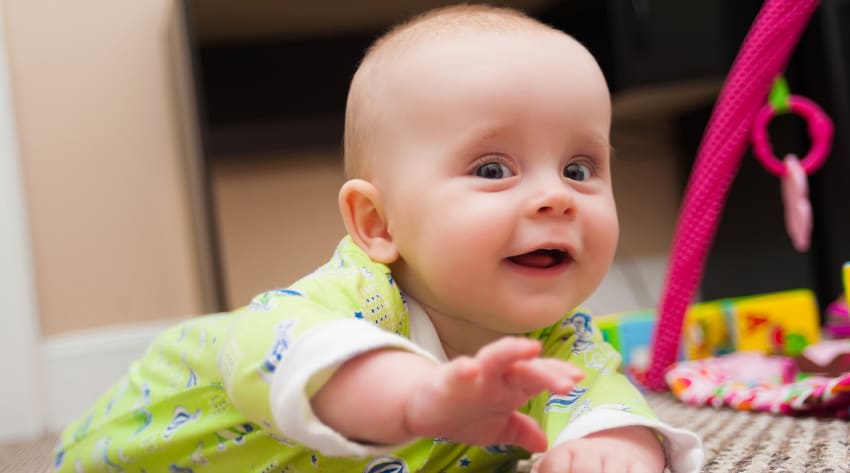 Baby playing on carpet