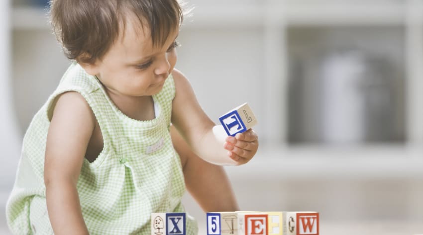 Toddler playing with building blocks