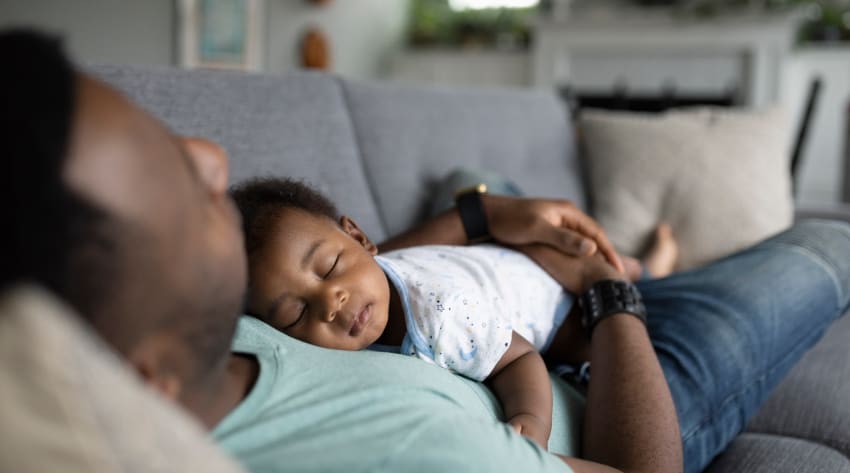 Baby sleeping on father’s chest