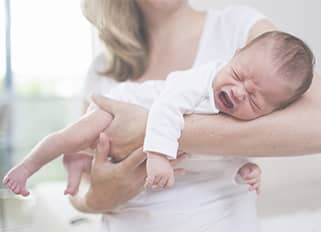 Woman holding crying baby