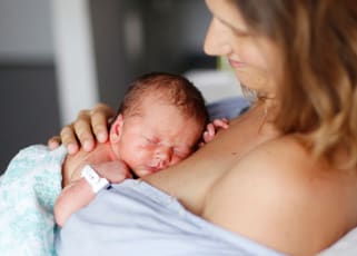 mother-holding-newborn-on-chest