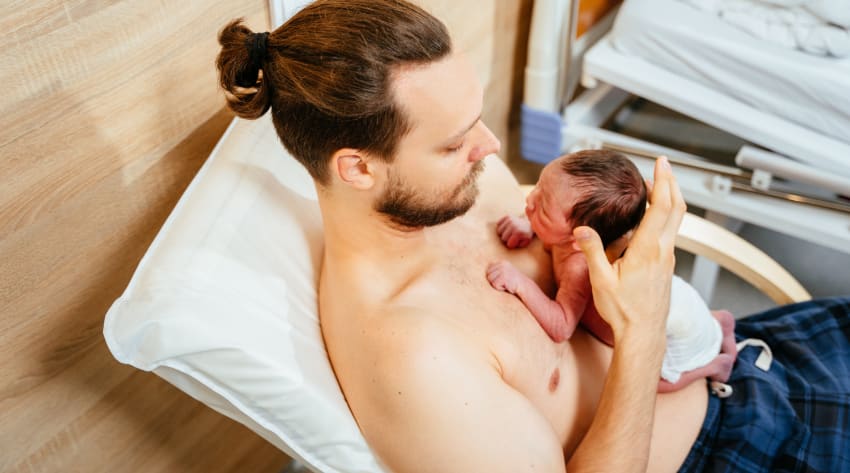 A father bonding with his child with skin-to-skin contact