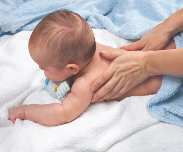 mother giving a baby massage