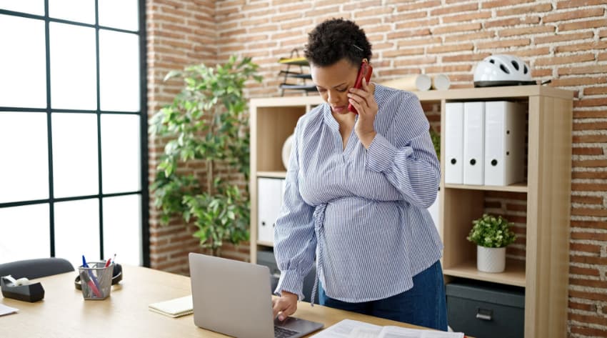 Pregnant mother at the office working