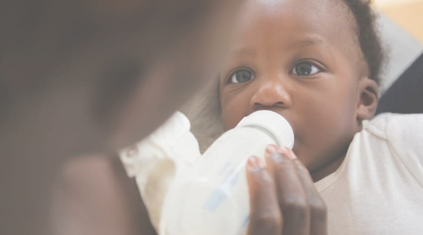 mother bottle feeding her newborn baby