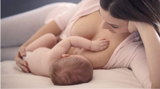 mother breastfeeding newborn baby