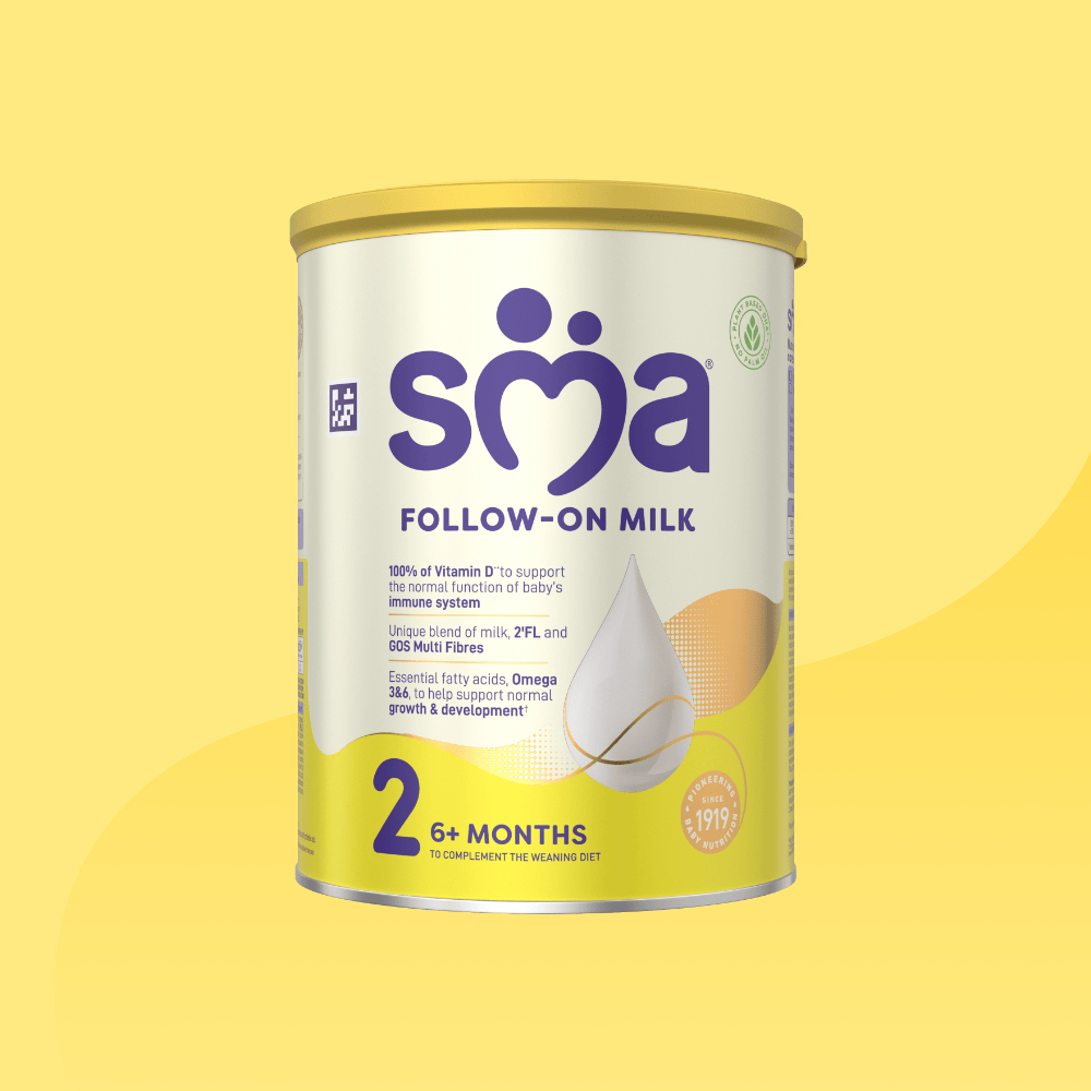 Tin of SMA Follow-on Milk Powder for babies 6-12 months with a yellow lid on a yellow background