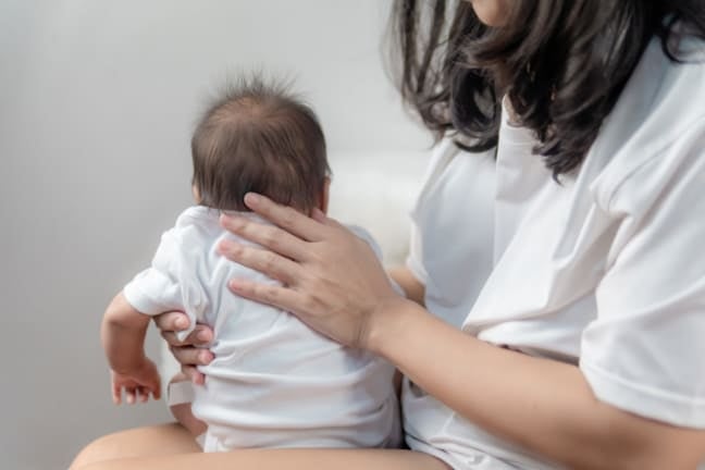 A mother burping her baby
