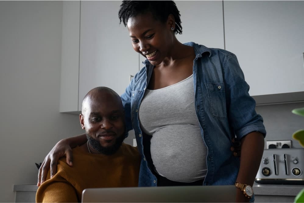 A couple looking at a laptop together