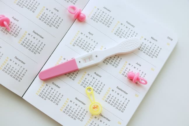 A pregnancy test in front of a diary