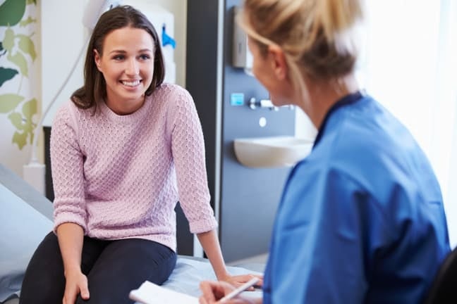 A mother talking to a midwife at her appointment