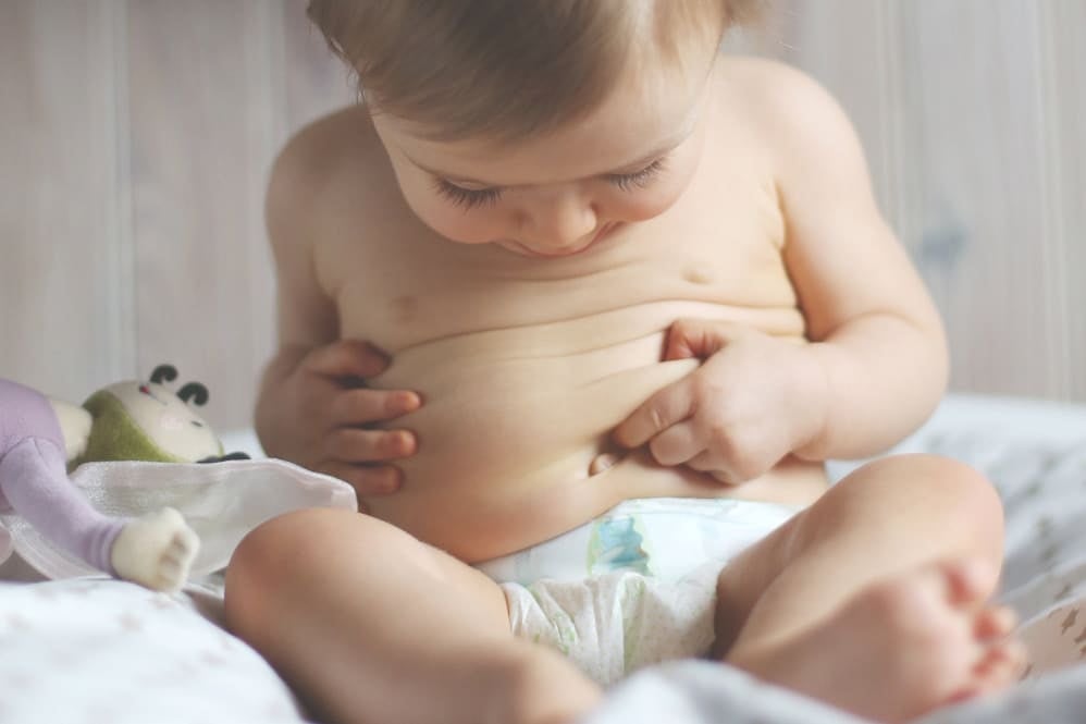 Infant looking at their gut area