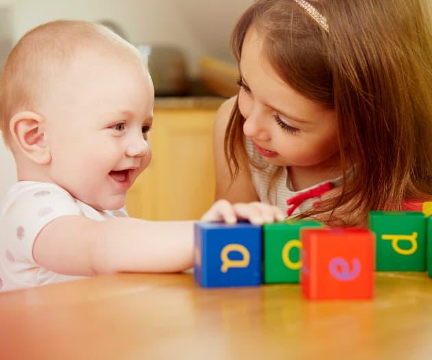 Child playing an interactive game with a toddler