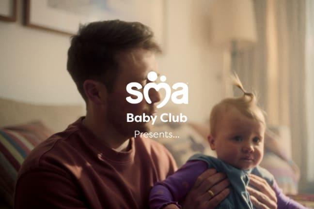 Image of father holding baby with a text overlay of SMA Baby Club presents