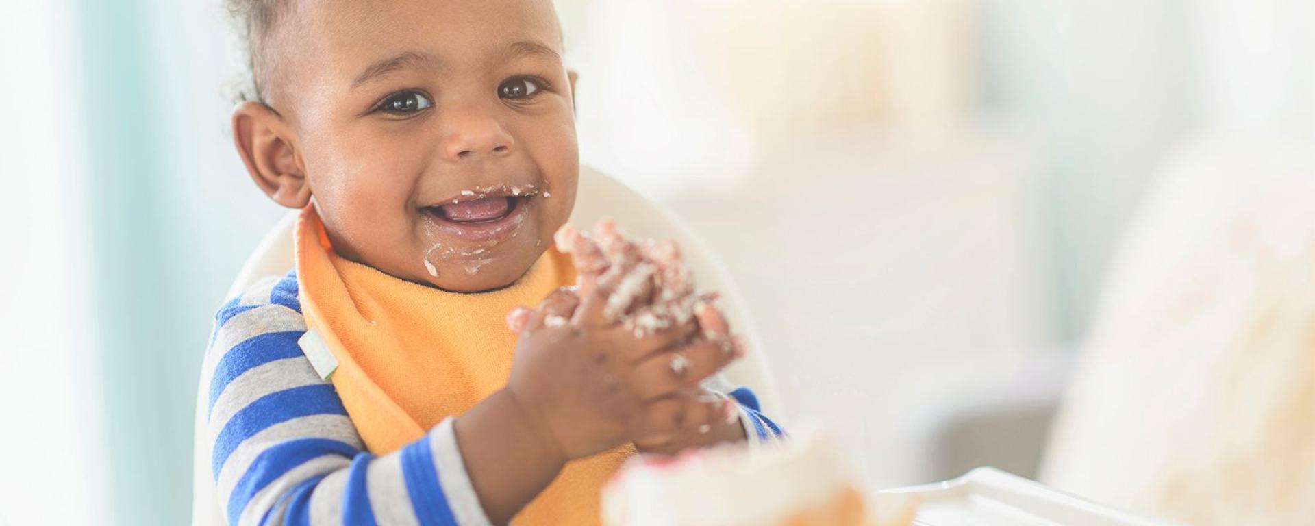 Baby playing with food while weaning